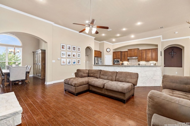 living room with crown molding and ceiling fan with notable chandelier