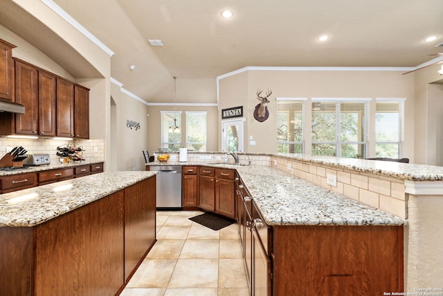 kitchen with sink, vaulted ceiling, kitchen peninsula, stainless steel appliances, and light stone countertops