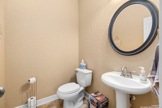 bathroom with tile patterned flooring and toilet