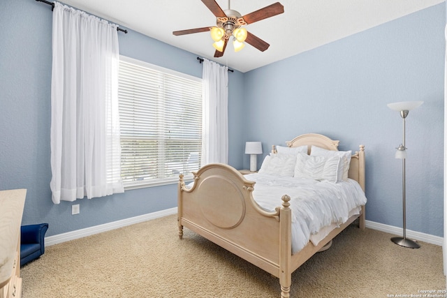 bedroom featuring multiple windows, carpet floors, and ceiling fan