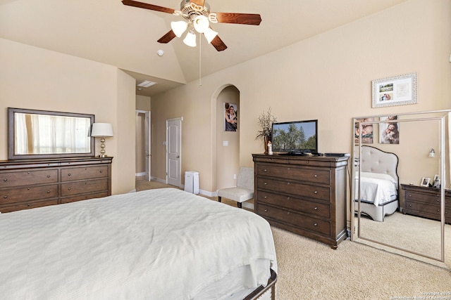 bedroom with vaulted ceiling, light colored carpet, and ceiling fan