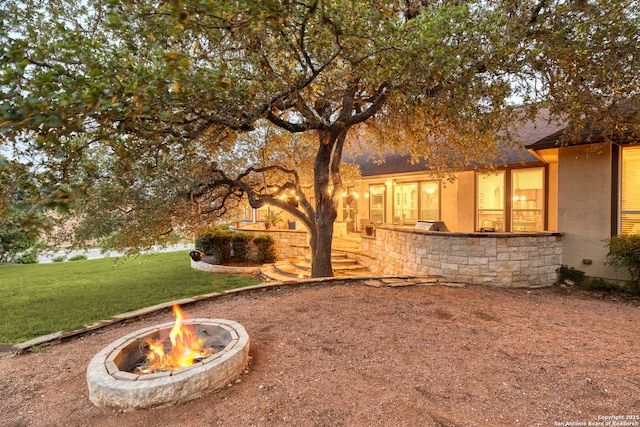 view of yard with an outdoor fire pit