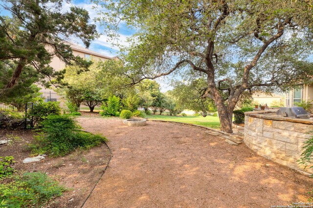 view of yard with a fire pit