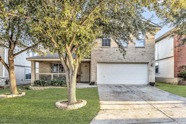 view of front of home with a porch, a garage, and a front lawn