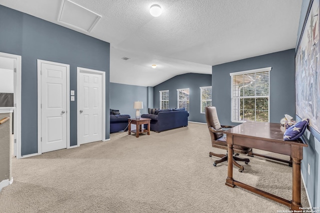 carpeted home office with lofted ceiling and a textured ceiling