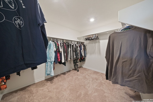 spacious closet featuring light carpet