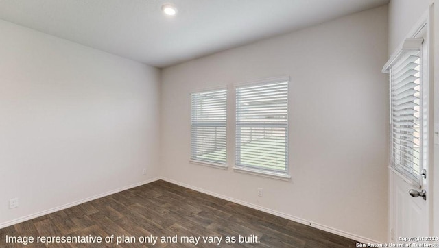 empty room featuring dark wood-type flooring