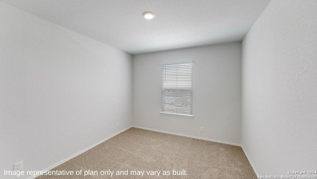 empty room featuring light colored carpet