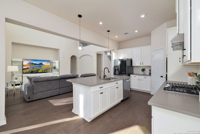 kitchen with white cabinetry, sink, stainless steel appliances, and a center island with sink