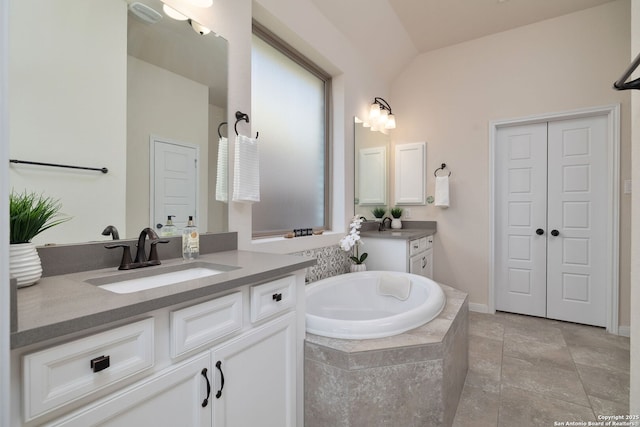 bathroom with vanity and vaulted ceiling