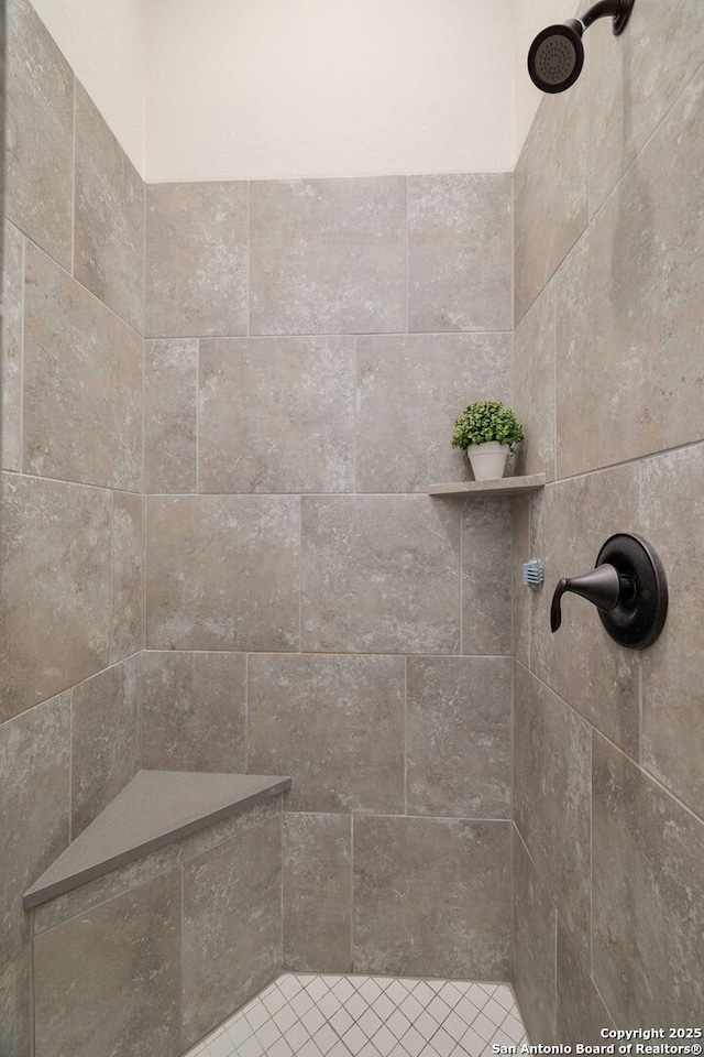 bathroom with a tile shower