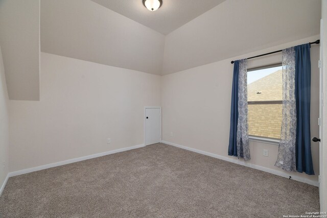 additional living space with lofted ceiling and carpet flooring