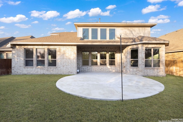 rear view of property featuring a patio and a lawn