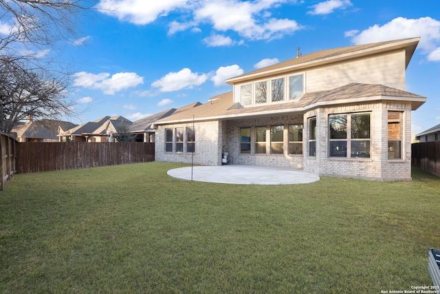 back of property with a patio and a lawn