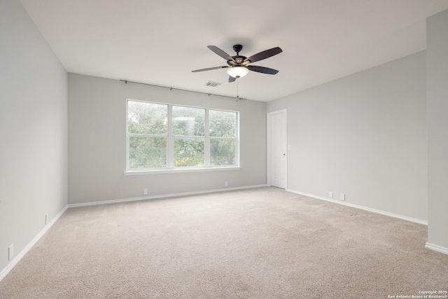 unfurnished room featuring ceiling fan, baseboards, visible vents, and light colored carpet