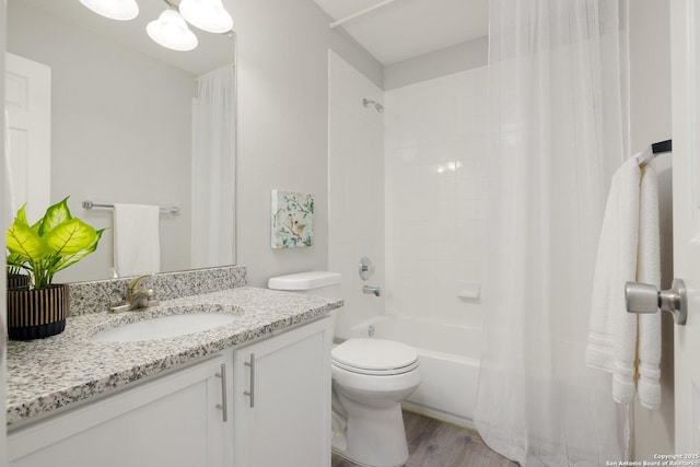 full bath with vanity, wood finished floors, toilet, and shower / bathtub combination with curtain