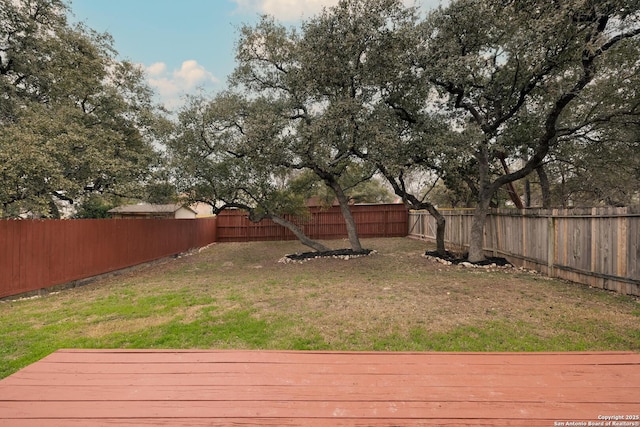 view of yard featuring a fenced backyard and a deck