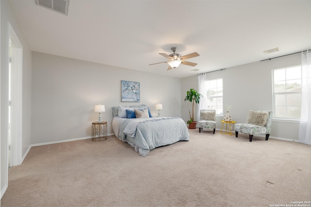 bedroom with light carpet, a ceiling fan, visible vents, and baseboards