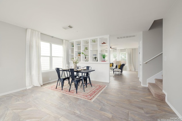 dining room featuring baseboards, stairs, and visible vents