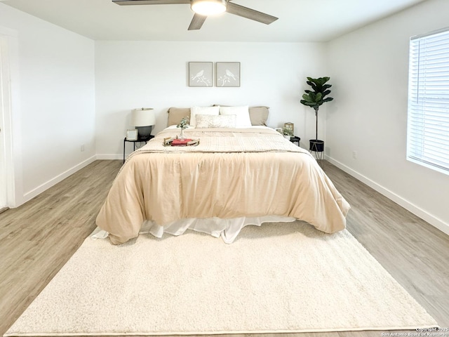 bedroom with ceiling fan and wood-type flooring