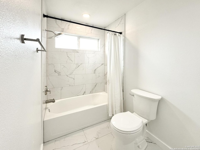 bathroom featuring shower / tub combo and toilet