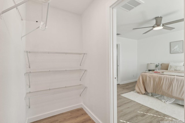 bedroom with wood-type flooring and ceiling fan