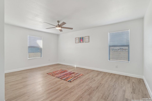 empty room featuring ceiling fan and light wood-type flooring