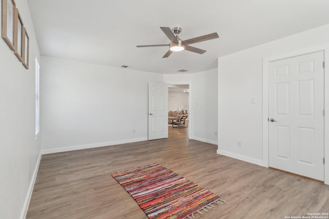 unfurnished room with ceiling fan and light hardwood / wood-style flooring