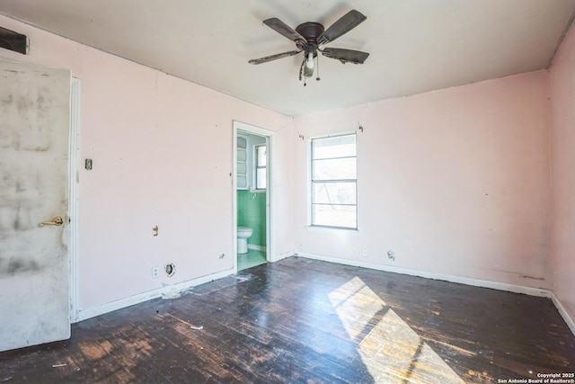 empty room featuring dark wood-type flooring and ceiling fan