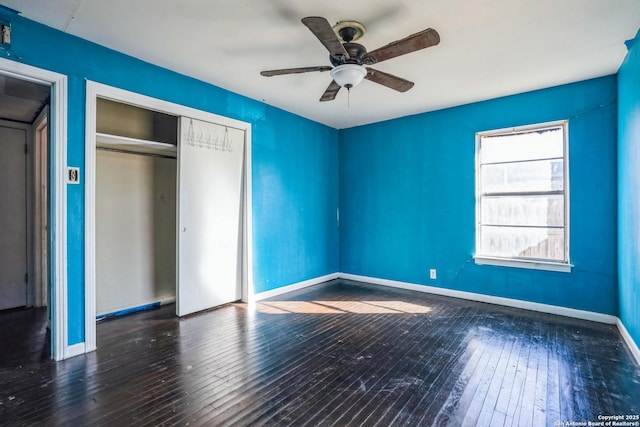 unfurnished bedroom featuring dark hardwood / wood-style floors, a closet, and ceiling fan