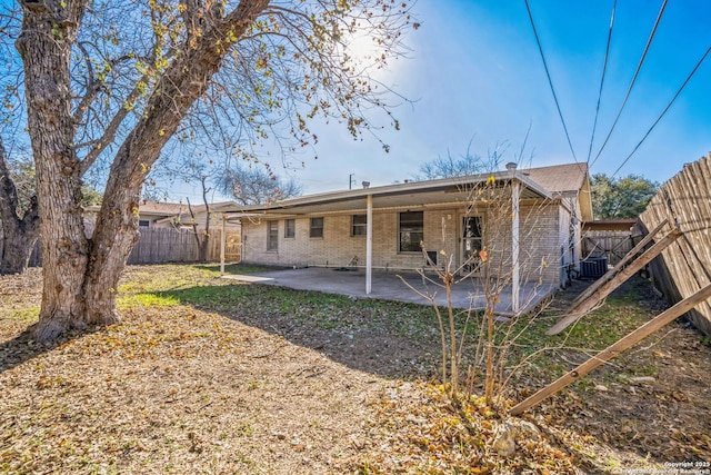 back of property featuring cooling unit and a patio