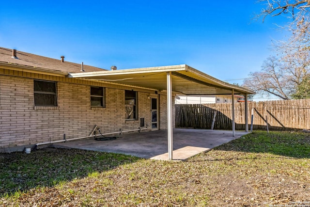 back of house featuring a patio area and a lawn