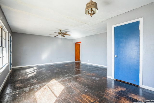 spare room featuring ceiling fan and dark hardwood / wood-style flooring