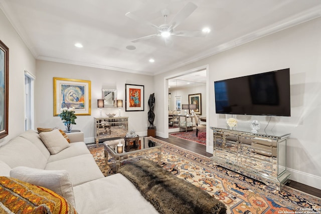 living room with hardwood / wood-style floors, ornamental molding, and ceiling fan