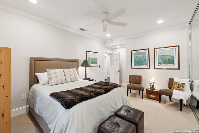 bedroom featuring light colored carpet, ornamental molding, and ceiling fan