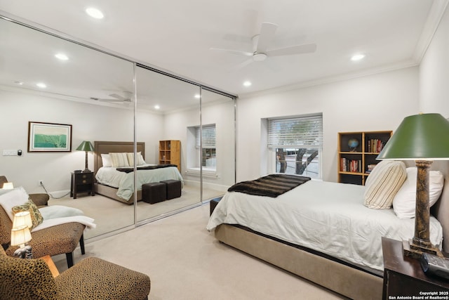 bedroom featuring crown molding, light carpet, and ceiling fan