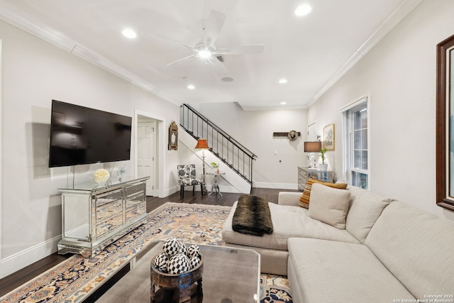 living room featuring crown molding, dark wood-type flooring, and ceiling fan