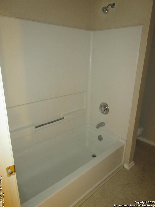 bathroom with shower / tub combination and toilet