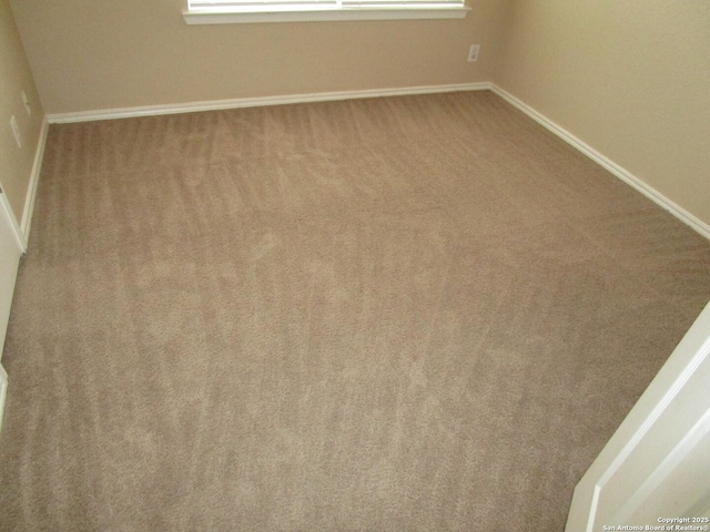 empty room featuring light colored carpet