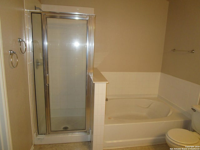 bathroom featuring tile patterned floors, shower with separate bathtub, and toilet