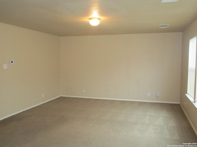 unfurnished room featuring light colored carpet