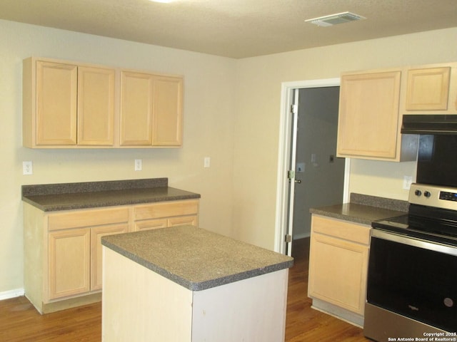 kitchen featuring hardwood / wood-style flooring, stainless steel electric stove, and a center island