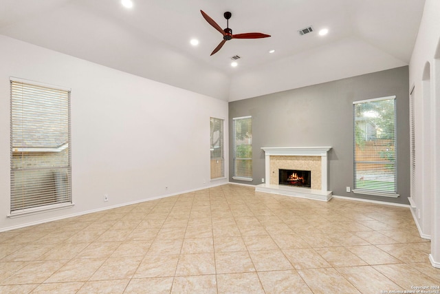 unfurnished living room with vaulted ceiling, ceiling fan, and light tile patterned flooring