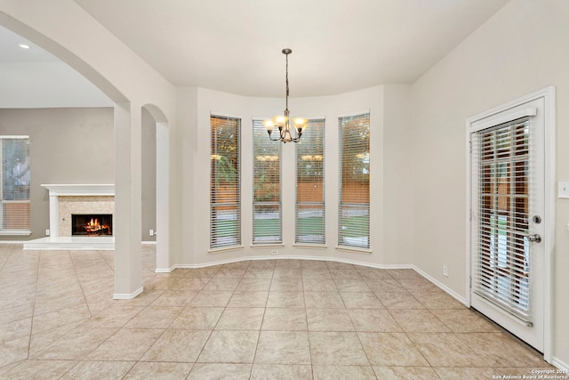 unfurnished dining area with an inviting chandelier and light tile patterned flooring