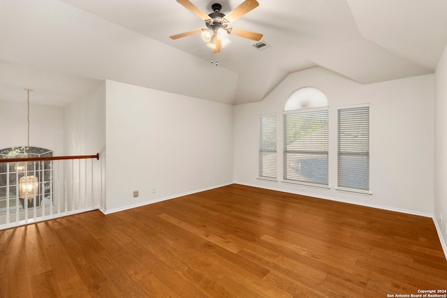 unfurnished room with hardwood / wood-style flooring, vaulted ceiling, and ceiling fan