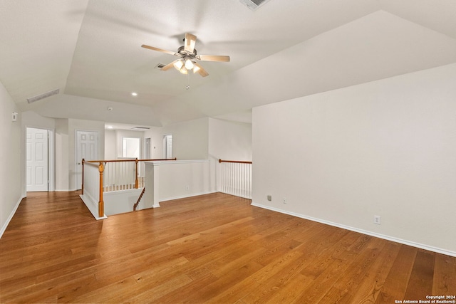 empty room featuring ceiling fan, vaulted ceiling, and hardwood / wood-style floors