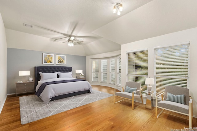 bedroom with vaulted ceiling, wood-type flooring, and ceiling fan