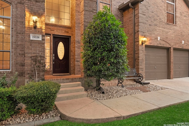 view of exterior entry with a garage