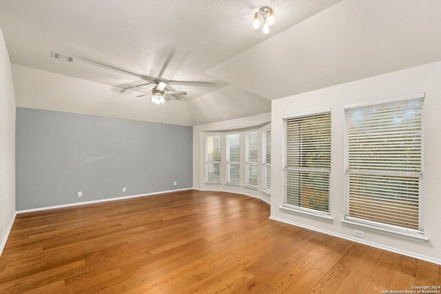 interior space with vaulted ceiling, wood-type flooring, and ceiling fan