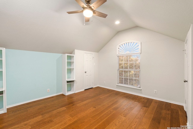 additional living space with lofted ceiling, hardwood / wood-style floors, and ceiling fan